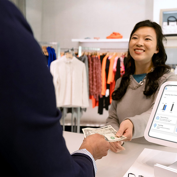 Woman making a sales transaction with cash.